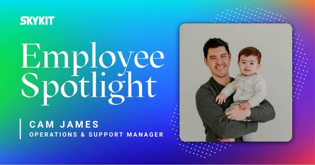 Employee feature story with text on image "Employee Spotlight Cam James" . Picture of Man with baby